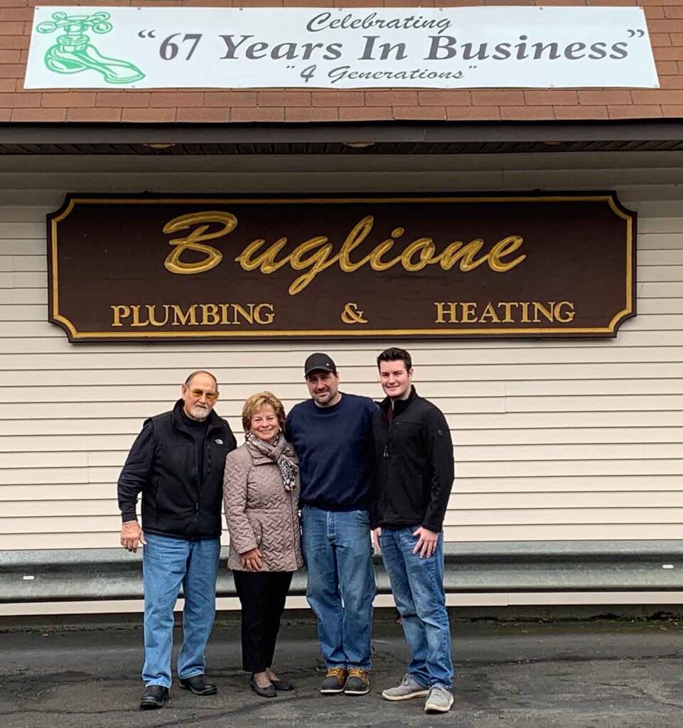 4 member of Buglione family in front of Buglione Plumbing building